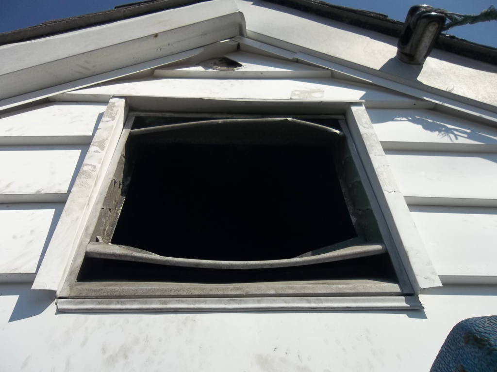 Gable vent ripped open by raccoons allowing attic access into a Connecticut home